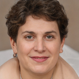 Joyful white adult female with short  brown hair and brown eyes