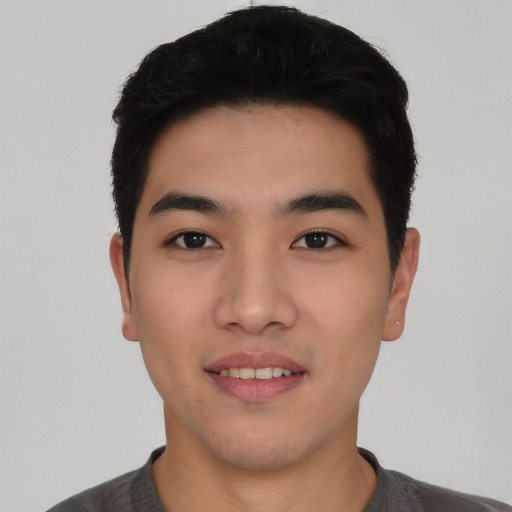 Joyful asian young-adult male with short  black hair and brown eyes