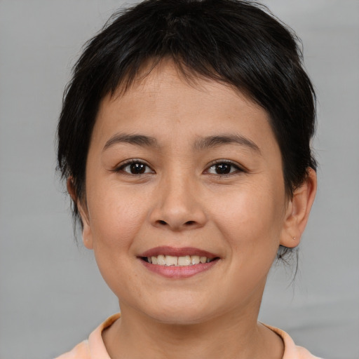 Joyful asian young-adult female with medium  brown hair and brown eyes