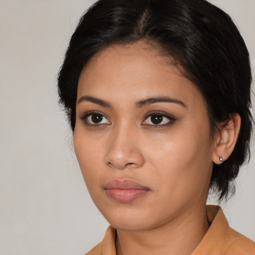 Neutral latino young-adult female with medium  brown hair and brown eyes