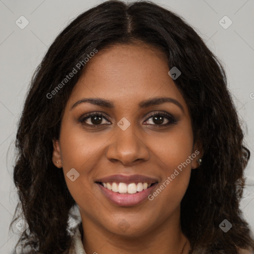 Joyful black young-adult female with long  brown hair and brown eyes