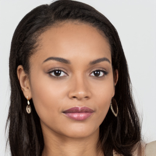 Joyful latino young-adult female with long  brown hair and brown eyes