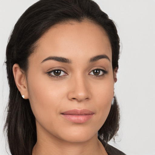 Joyful latino young-adult female with long  brown hair and brown eyes