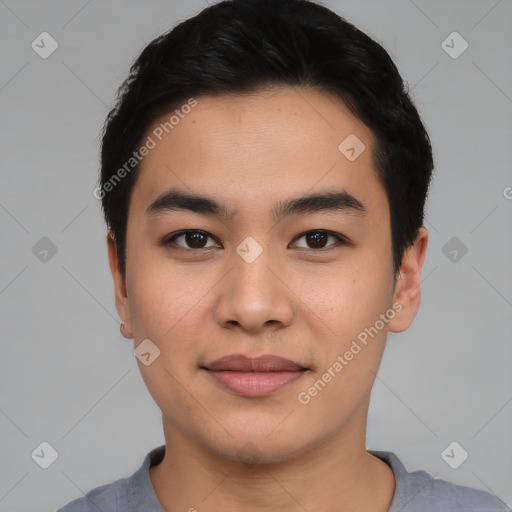 Joyful asian young-adult male with short  black hair and brown eyes