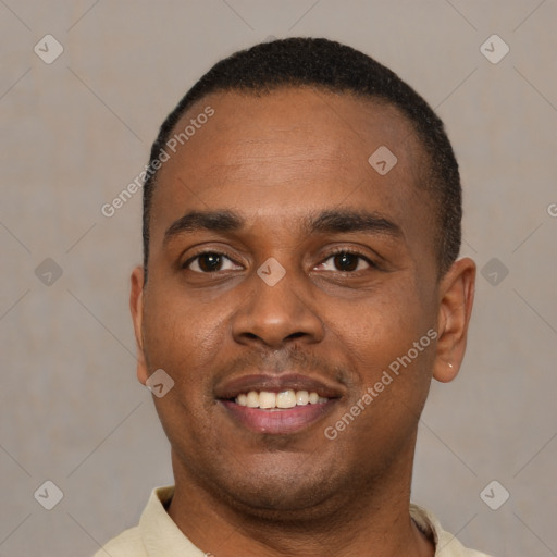 Joyful latino young-adult male with short  black hair and brown eyes