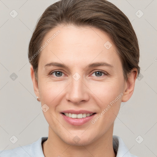 Joyful white young-adult female with short  brown hair and grey eyes