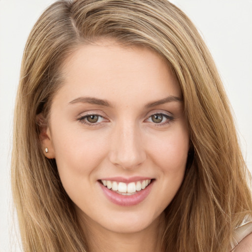 Joyful white young-adult female with long  brown hair and green eyes