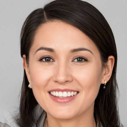 Joyful white young-adult female with medium  brown hair and brown eyes