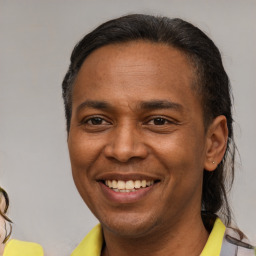 Joyful latino young-adult male with short  brown hair and brown eyes