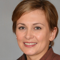 Joyful white adult female with medium  brown hair and brown eyes