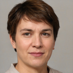 Joyful white adult female with short  brown hair and brown eyes