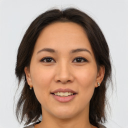 Joyful asian young-adult female with medium  brown hair and brown eyes