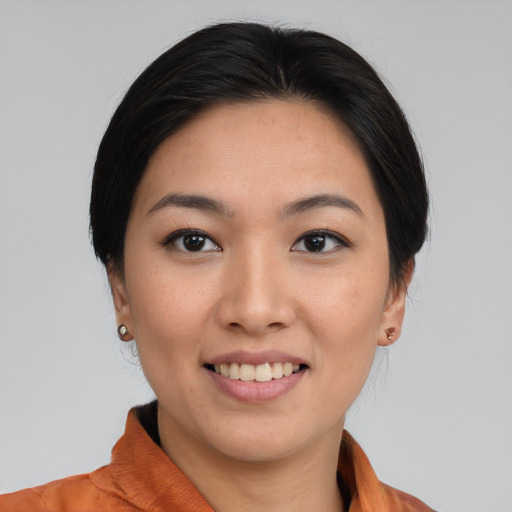 Joyful asian young-adult female with medium  black hair and brown eyes