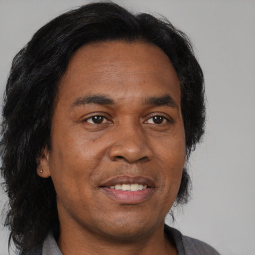 Joyful black adult male with short  brown hair and brown eyes