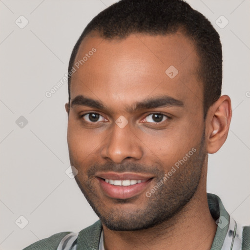 Joyful black young-adult male with short  brown hair and brown eyes