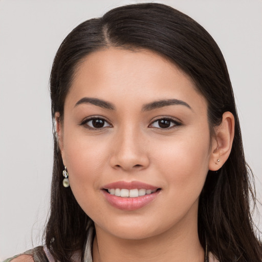 Joyful white young-adult female with long  brown hair and brown eyes