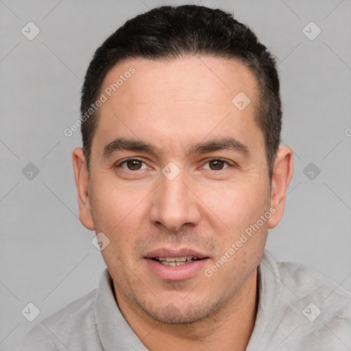 Joyful white young-adult male with short  black hair and brown eyes