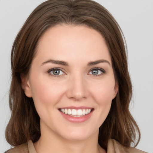 Joyful white young-adult female with medium  brown hair and green eyes