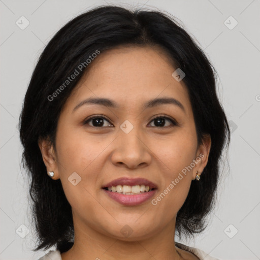 Joyful latino young-adult female with medium  brown hair and brown eyes