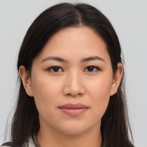 Joyful asian young-adult female with long  brown hair and brown eyes