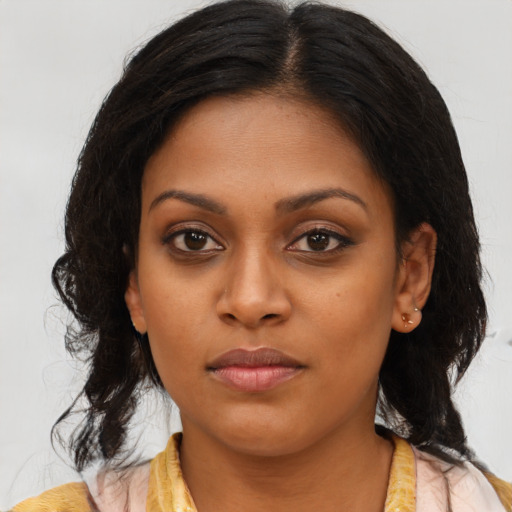 Joyful black young-adult female with medium  brown hair and brown eyes