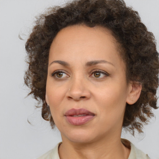 Joyful black adult female with medium  brown hair and brown eyes