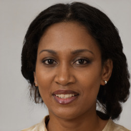 Joyful black adult female with medium  brown hair and brown eyes