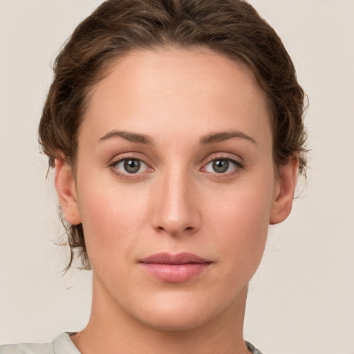 Joyful white young-adult female with medium  brown hair and green eyes