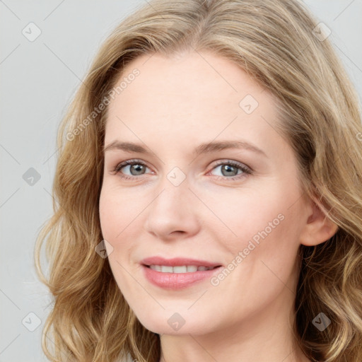 Joyful white young-adult female with long  brown hair and blue eyes