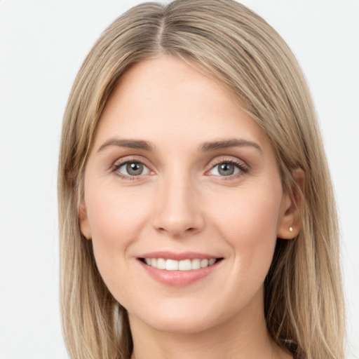 Joyful white young-adult female with long  brown hair and green eyes