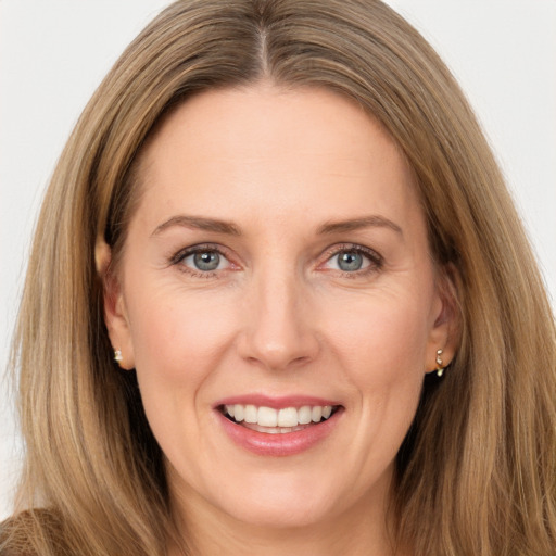 Joyful white adult female with long  brown hair and grey eyes