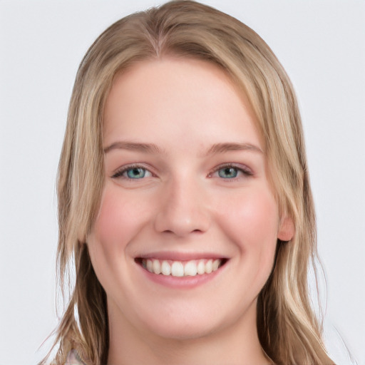 Joyful white young-adult female with long  brown hair and blue eyes