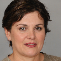 Joyful white adult female with medium  brown hair and brown eyes