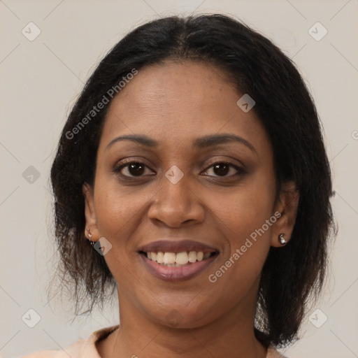 Joyful black adult female with medium  brown hair and brown eyes