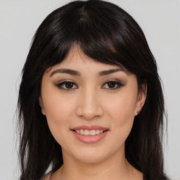 Joyful asian young-adult female with long  brown hair and brown eyes