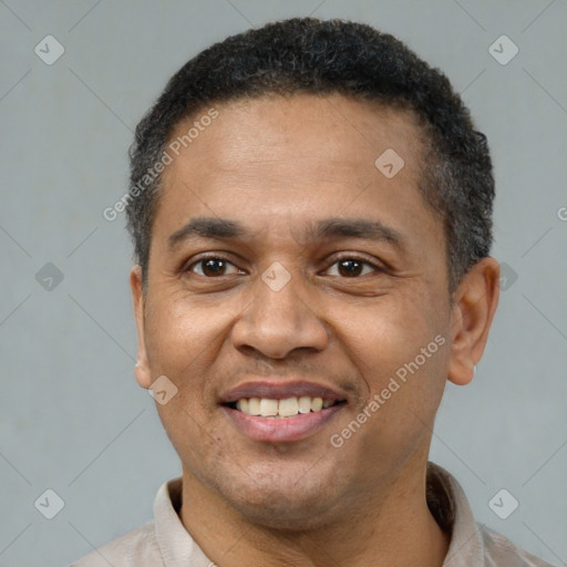 Joyful latino adult male with short  brown hair and brown eyes