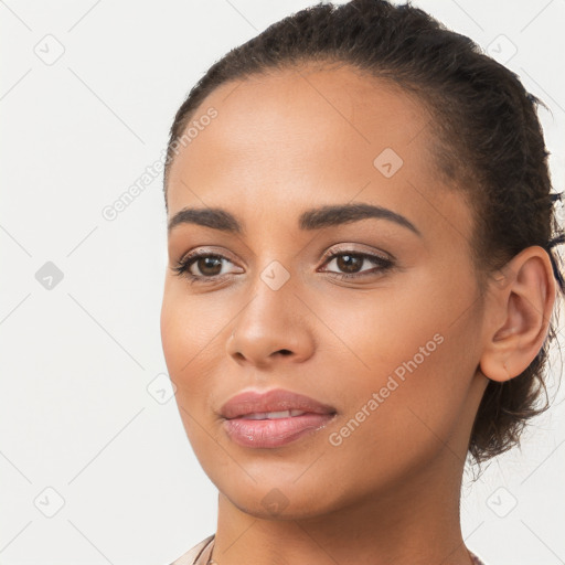 Joyful latino young-adult female with long  brown hair and brown eyes