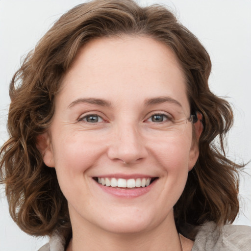 Joyful white young-adult female with medium  brown hair and blue eyes