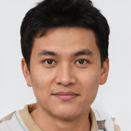 Joyful asian young-adult male with short  brown hair and brown eyes