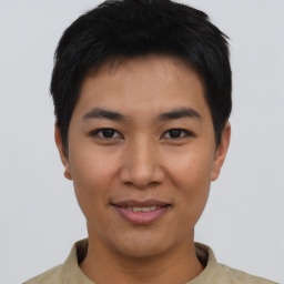 Joyful asian young-adult male with short  black hair and brown eyes