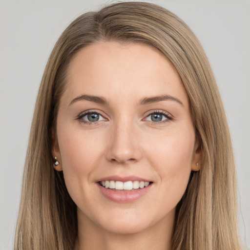 Joyful white young-adult female with long  brown hair and brown eyes