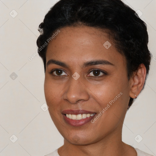 Joyful latino young-adult female with short  black hair and brown eyes