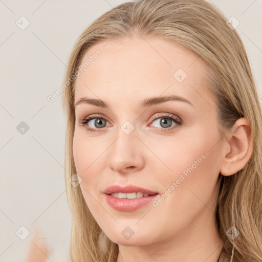 Joyful white young-adult female with long  brown hair and blue eyes