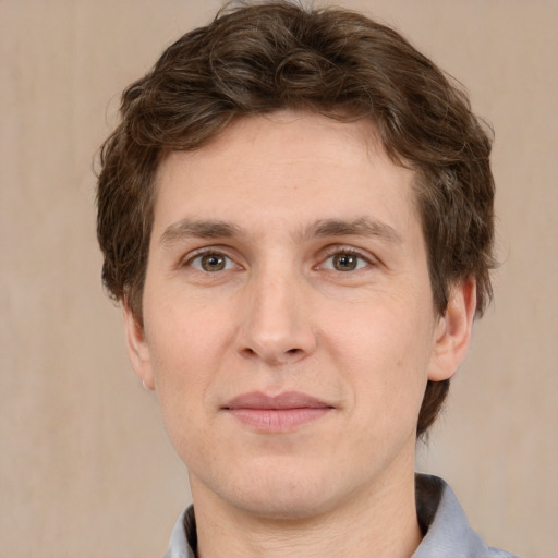 Joyful white adult male with short  brown hair and grey eyes