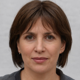 Joyful white adult female with medium  brown hair and grey eyes