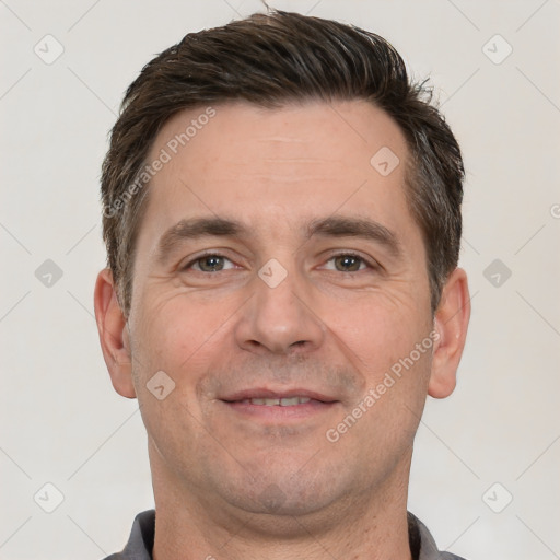 Joyful white adult male with short  brown hair and brown eyes