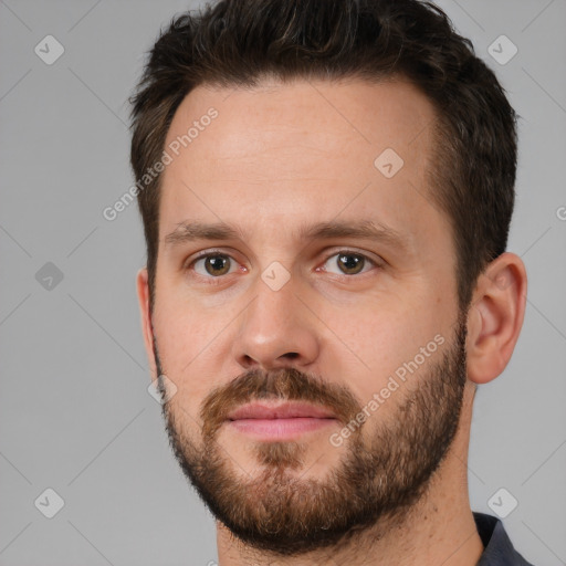 Joyful white young-adult male with short  brown hair and brown eyes