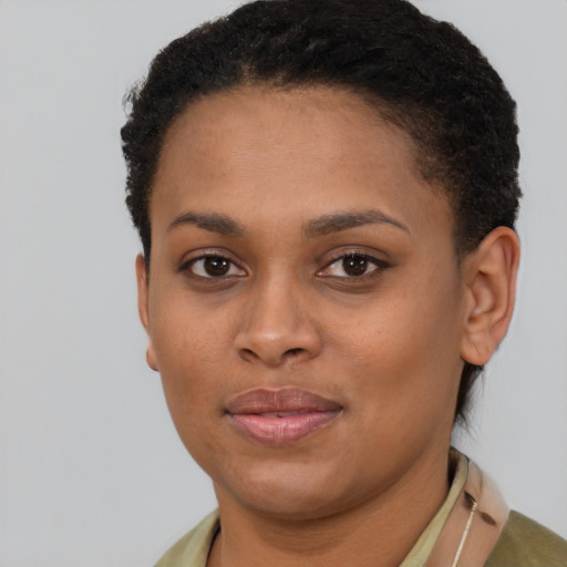 Joyful black young-adult female with short  brown hair and brown eyes
