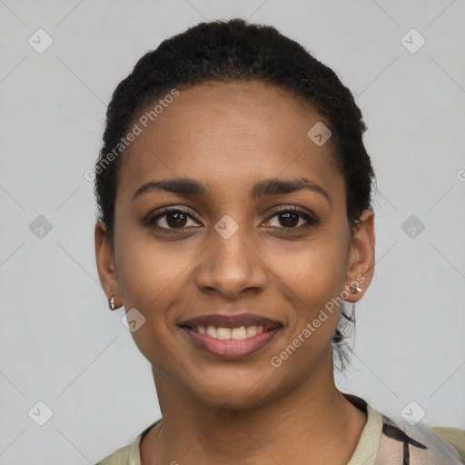 Joyful black young-adult female with short  black hair and brown eyes