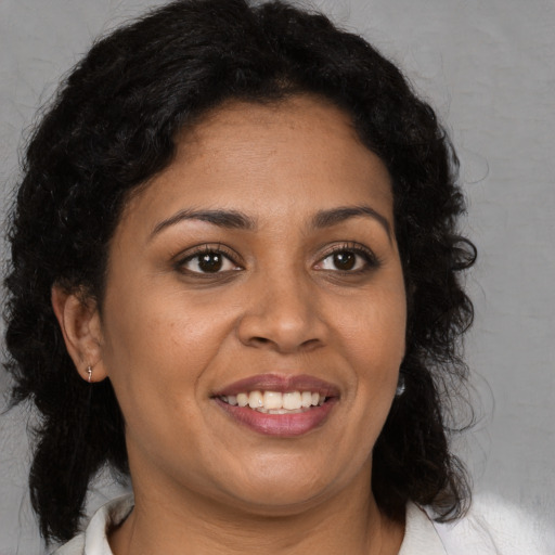 Joyful black young-adult female with medium  brown hair and brown eyes
